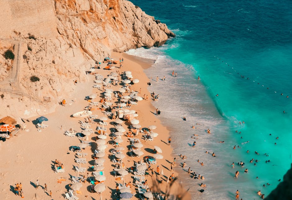 A breathtaking aerial view of a crowded beach with turquoise waters