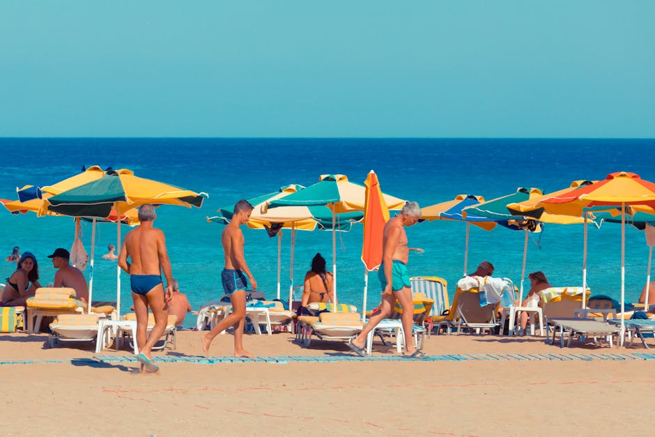 Vibrant beach scene with colorful umbrellas and people relaxing by the sea