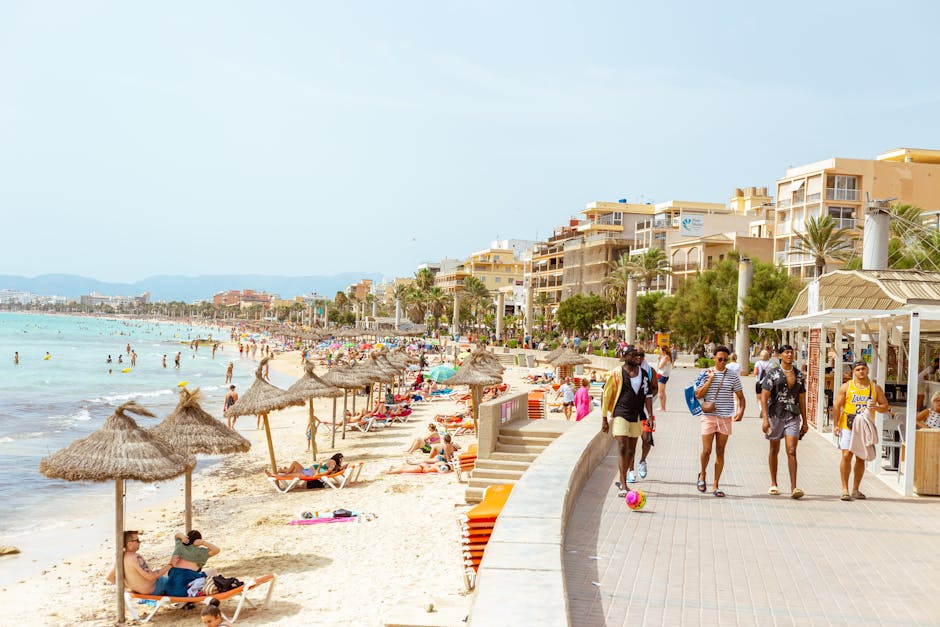 Sunny day at a bustling Ibiza beach with people enjoying leisure activities. Ideal for vacation and tourism content